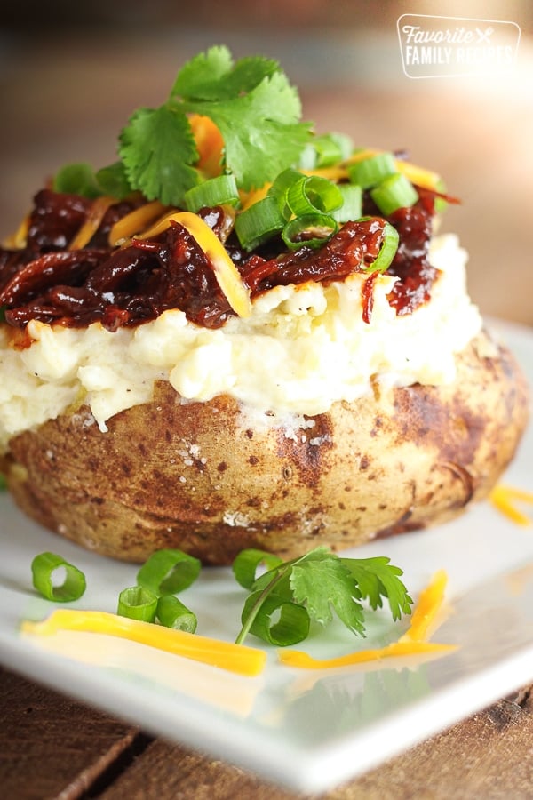 BBQ Beef Twice Baked Potato on a white plate.