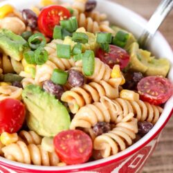 BBQ Ranch Pasta Salad in a red bowl with a silver spoon.