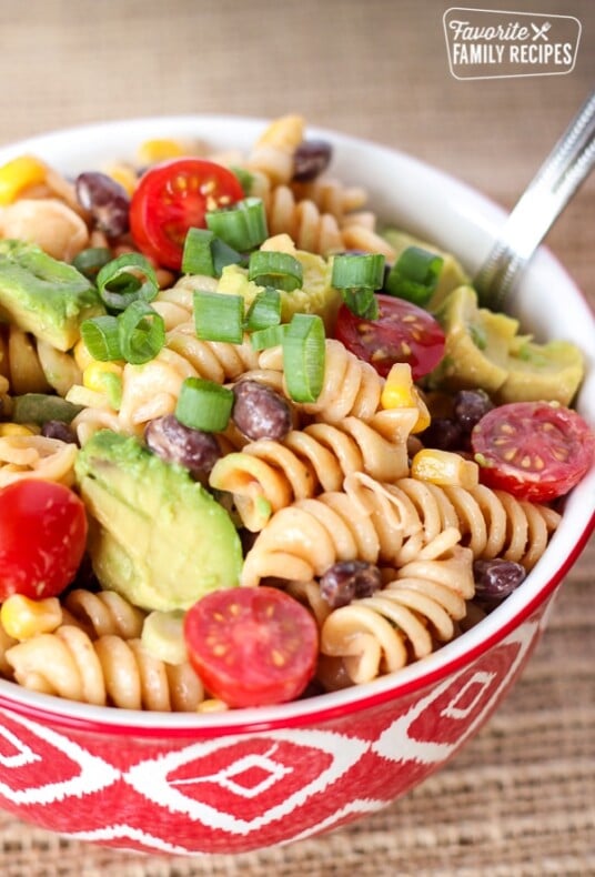 BBQ Ranch Pasta Salad in a red bowl with a silver spoon.