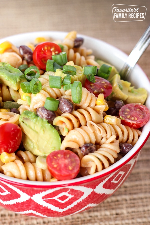 BBQ Ranch Pasta Salad in a red bowl with a silver spoon.