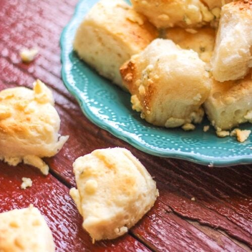 Several Blue Cheese bombs stacked on a blue plate