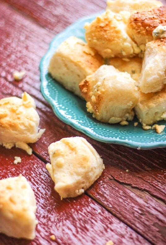 Several Blue Cheese bombs stacked on a blue plate