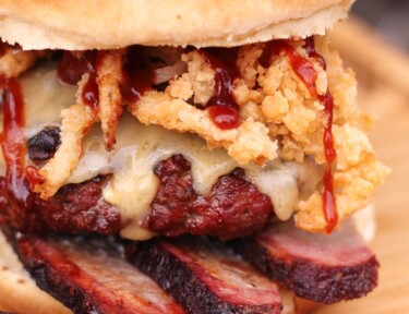 Blue cheese smoked brisket burger on a wooden surface