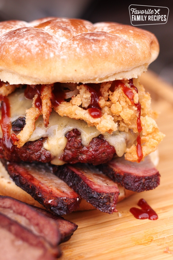 Blue cheese smoked brisket burger on a wooden surface.