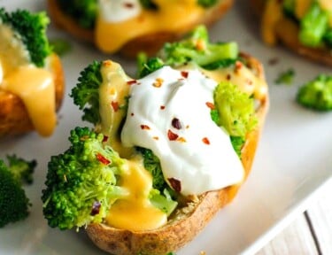 Broccoli Cheese Stuffed Potato Skins on a white plate.