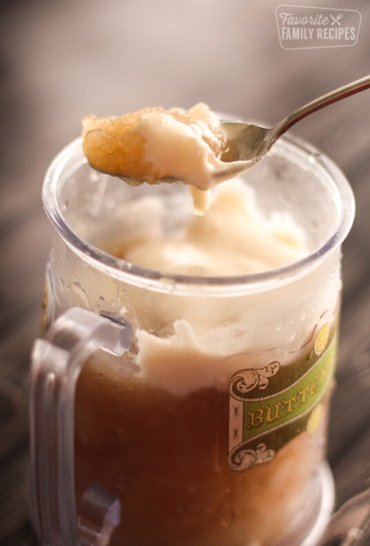 Frozen Butterbeer in a glass mug and a spoon scooping some out.
