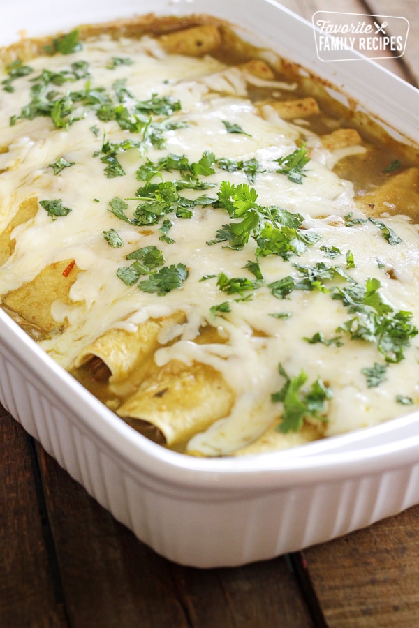 Enchiladas in a white baking dish. 