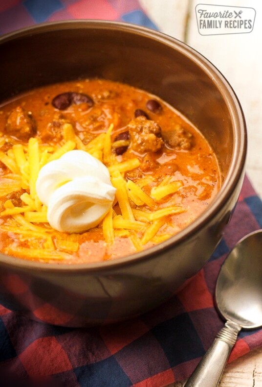 Close up of Creamy Italian Sausage Chili with a dollop of sour cream in a bowl.