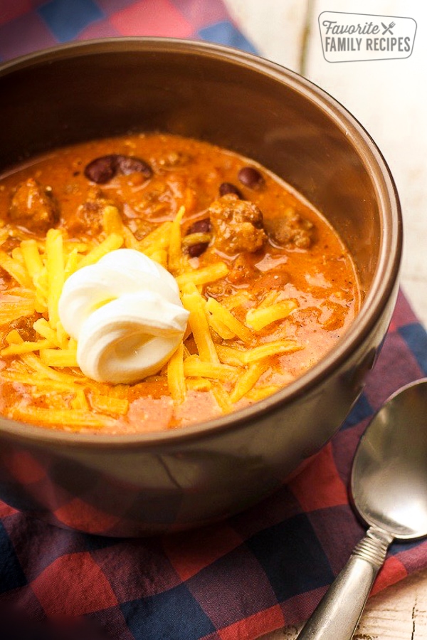 Close up of Creamy Italian Sausage Chili with a dollop of sour cream in a bowl.