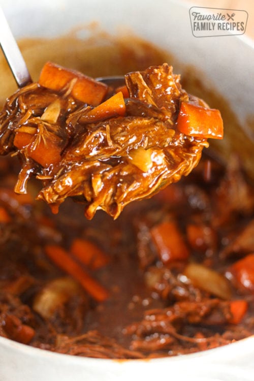 Danish Goulash beef and carrots in a bowl and on a spoon