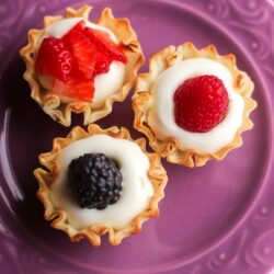 Overhead view of 3 Easy Phyllo Fruit Cups on a purple plate.