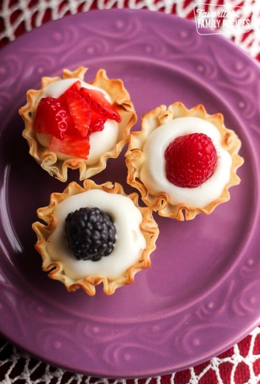 Overhead view of 3 Easy Phyllo Fruit Cups on a purple plate.