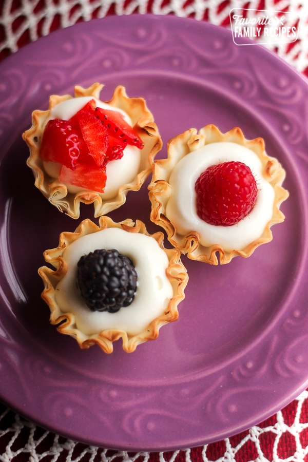 Overhead view of 3 Easy Phyllo Fruit Cups on a purple plate.