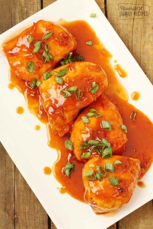 Apricot chicken in sauce on a white platter