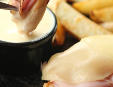 Slice of Grilled Malibu Chicken with a fork dipping a piece into a side of honey mustard.