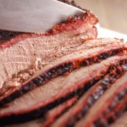 Smoked brisket sliced with a knife.