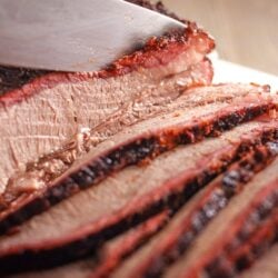 Smoked brisket sliced with a knife.