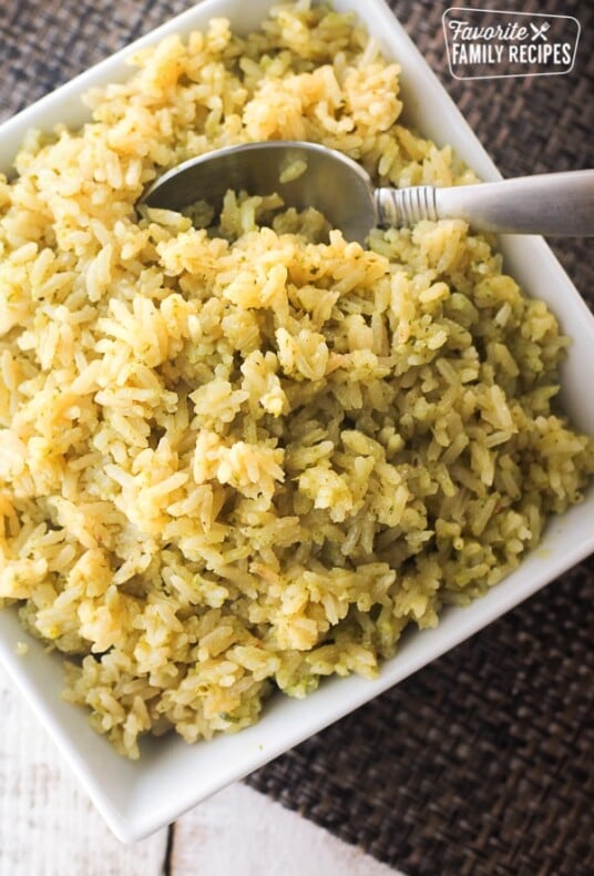 Lemon Pesto Rice in a white dish with a spoon on the side.