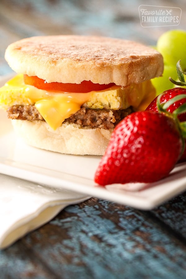 Light Freezer Breakfast Sandwich with a side of strawberries and grapes on a white plate.