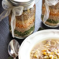 A Bowl of Love Soup Next with mason Jars of Love Soup Mix in the background.