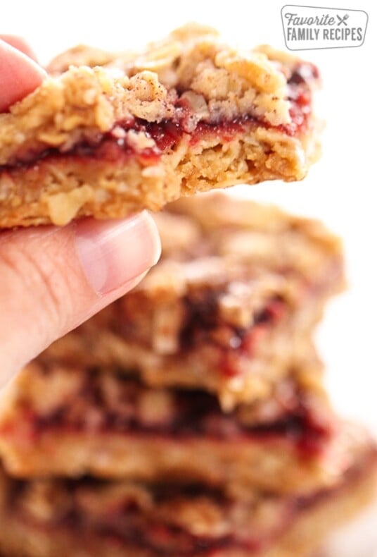 Close up of a hand holding an Oatmeal Raspberry Crumb Bar