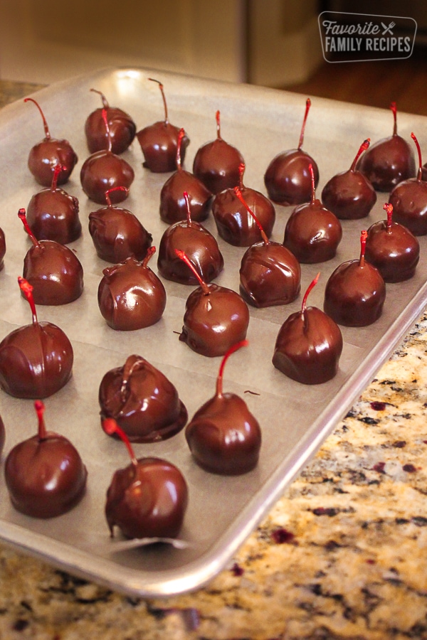 A baking sheet filled with chocolate covered cherries