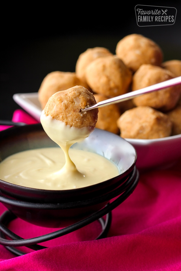 Peanut Butter Bon Bons being dipped in white chocolate.