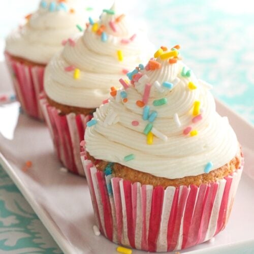 3 Easy Filled Cupcakes topped with rainbow sprinkles on a white tray