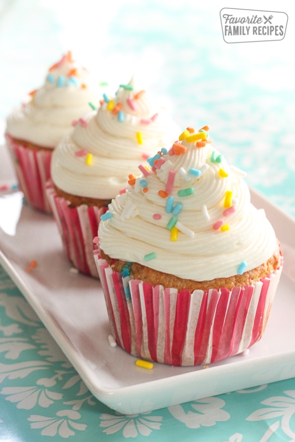 3 Easy Filled Cupcakes topped with rainbow sprinkles on a white tray