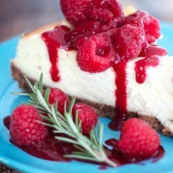cheesecake with raspberries on a blue plate