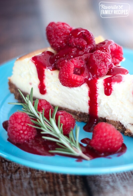 cheesecake with raspberries on a blue plate