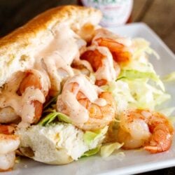 Shrimp po boy sandwich with creamy cajun sauce on a hoagie bun with shredded cabbage