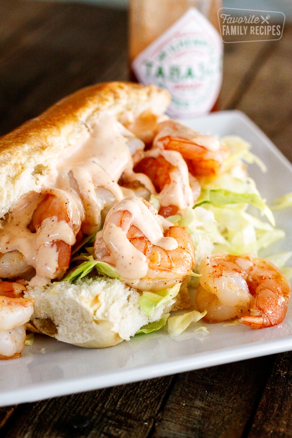 Shrimp po boy sandwich with creamy cajun sauce on a hoagie bun with shredded cabbage