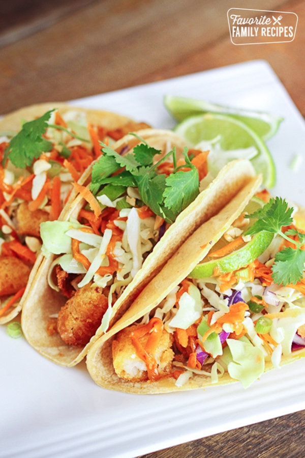 Fish tacos on a white plate. 
