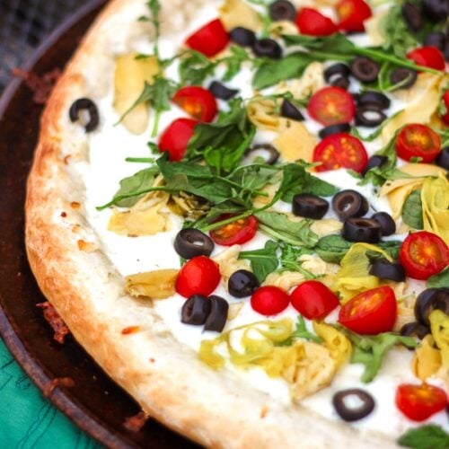 Antipasto Pizza on a metal circular tray.
