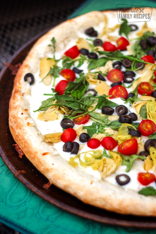 Antipasto Pizza on a metal circular tray.