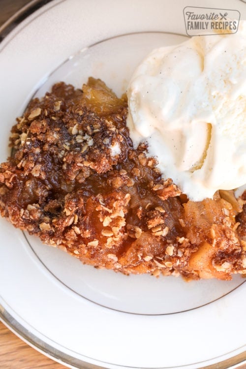 Slice of gluten free apple pie with ice cream.