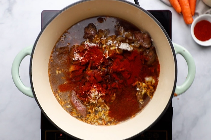 Beef, onion soup mix, beef broth, paprika, Worcestershire, and soy sauce in a large pot for Thick and Beefy Danish Goulash.