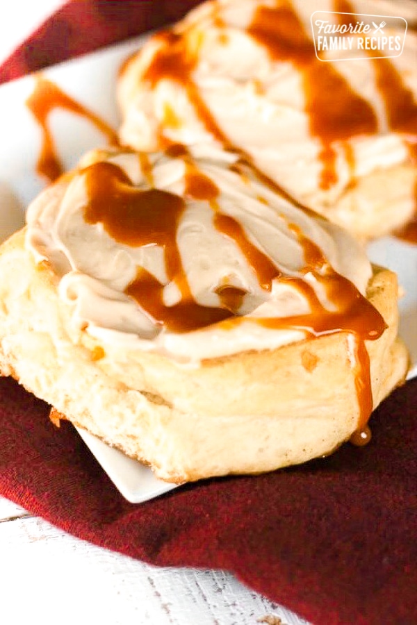 Caramel Apple Cinnamon Rolls on a white plate.