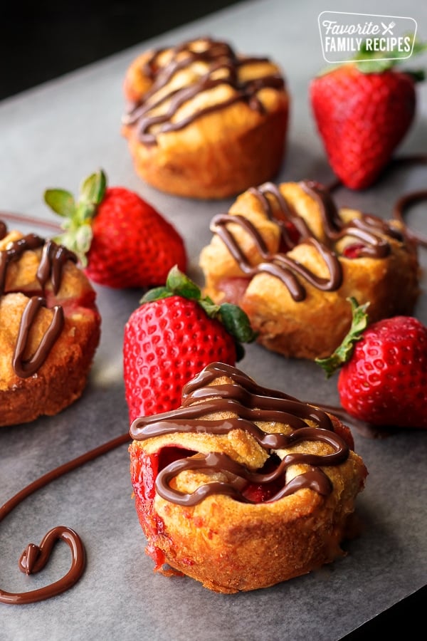 Chocolate covered Strawberry Tarts on parchment paper.