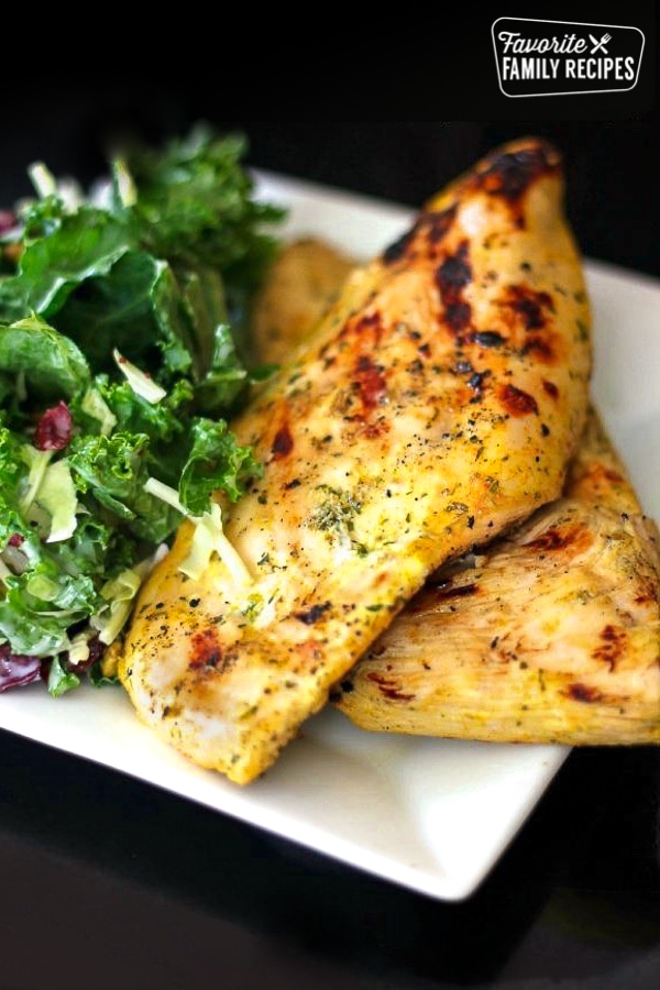 2 pieces of Coconut Curry Grilled Chicken with a salad on the side.