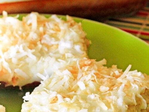A close up of a piece of Coconut Lime Cheesecake Bars on a green plate.