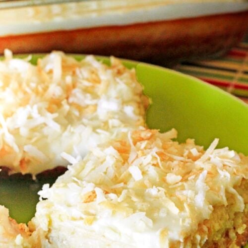 A close up of a piece of Coconut Lime Cheesecake Bars on a green plate.