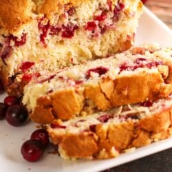 Sliced Cranberry Almond Bread on a white plate