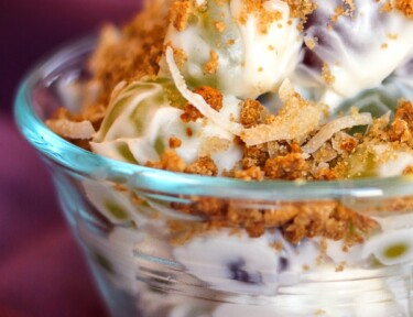 Creamy Grape Salad with Crunchy Coconut Topping in a small white bowl.