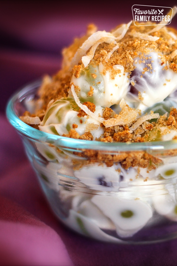 Creamy Grape Salad with Crunchy Coconut Topping in a small white bowl.