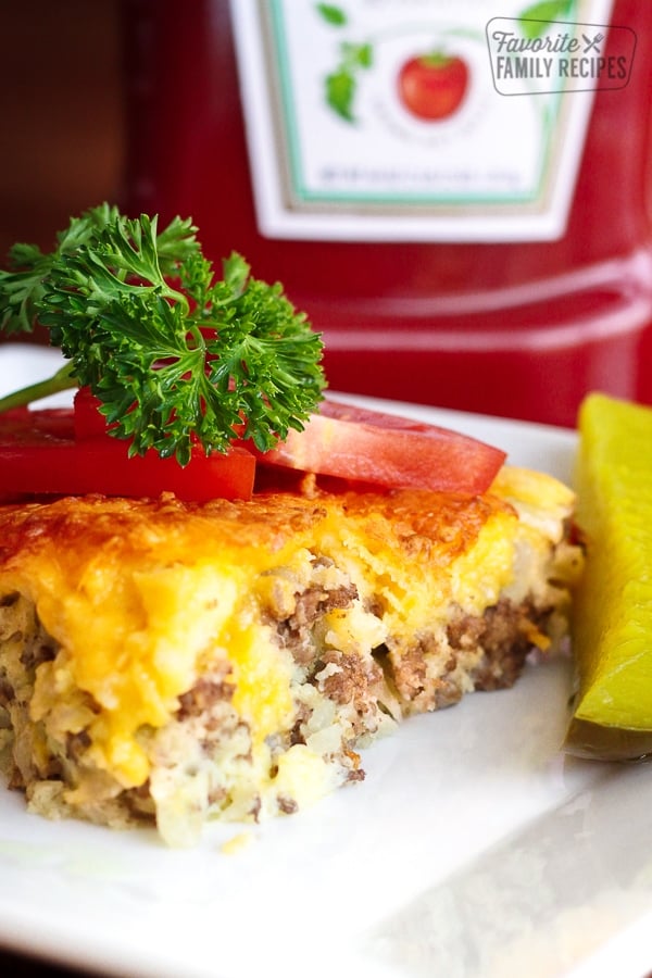 Easy Cheeseburger Pie topped with tomatoes and a garnish.