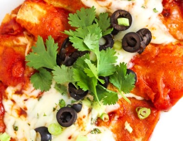 Overhead shot of Easy Cheesy Enchiladas topped with olives and cilantro.