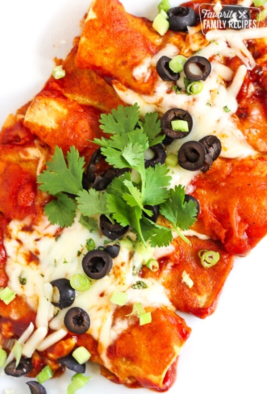 Overhead shot of Easy Cheesy Enchiladas topped with olives and cilantro.