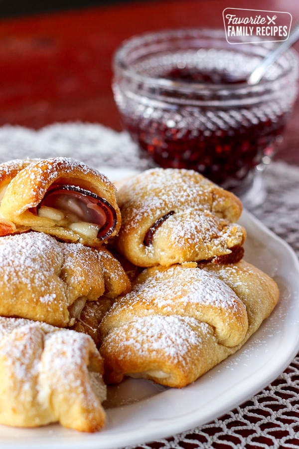 Easy Monte Cristos on a plate with a side of raspberry preserves.